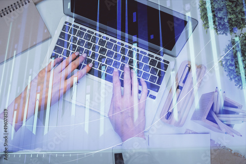 Double exposure of woman hands working on computer and forex graph hologram drawing. Top View. Financial analysis concept. © peshkova