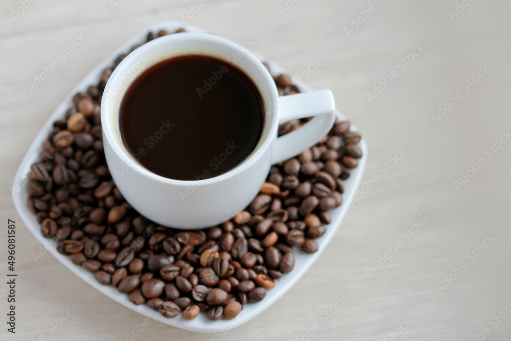 Coffee cup with coffee beans close up Coffee cup with coffee beans close up