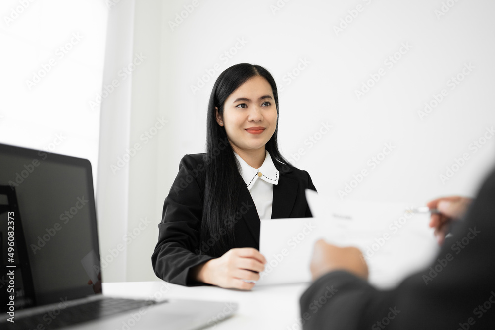 Business woman to greet a HR staff before a job interview to apply for a job. Happy woman seeker or insurance broker presenting a business deal. Smart asian woman sending resume. Business woman to greet a HR staff before a job interview to apply for a job. Happy woman seeker or insurance broker presenting a business deal. Smart asian woman sending resume.