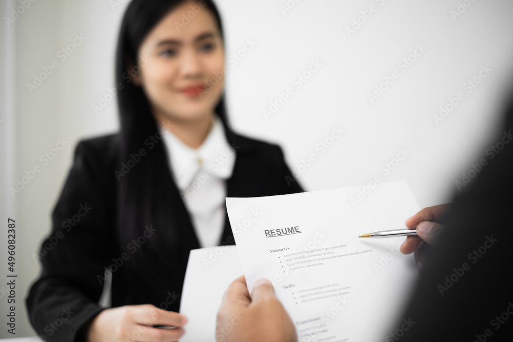 Business woman to greet a HR staff before a job interview to apply for a job. Happy woman seeker or insurance broker presenting a business deal. Smart asian woman sending resume. Business woman to greet a HR staff before a job interview to apply for a job. Happy woman seeker or insurance broker presenting a business deal. Smart asian woman sending resume.
