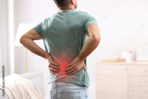 Papier peint Man suffering from back pain at home. Bad posture problem