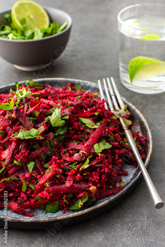 Vegetarian salad with couscous and grated beets, parsley and dill and green onions, light healthy tasty salad