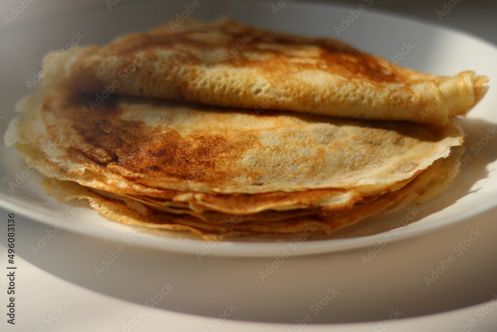 Slavic thin fried pancakes with a crispy golden crust in a stack Slavic thin fried pancakes with a crispy golden crust in a stack