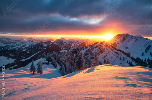 Colorful sunset over snowy mountain landscape in winter. Allgau Alps, Bavaria, Germany, Europe photo