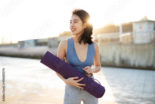 Beautiful young woman training outside. Fit woman doing stretching exercise.. © Jelena