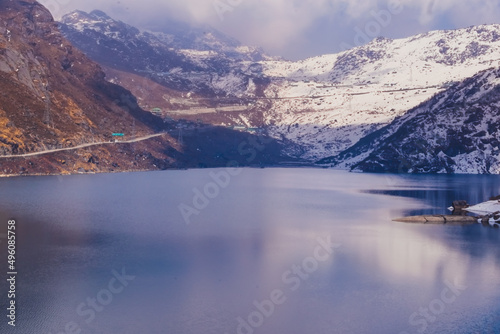 lake in mountains with snow and cloud.