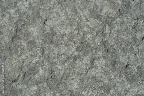Raw rough dark gray limestone close-up, textured. photo
