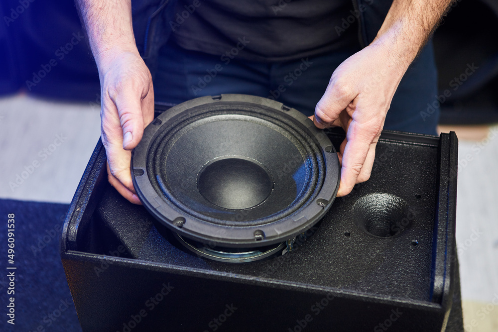 Worker is production speakers and loudspeakers at the factory. Handmade  creation of acoustic music systems Stock 写真 | Adobe Stock