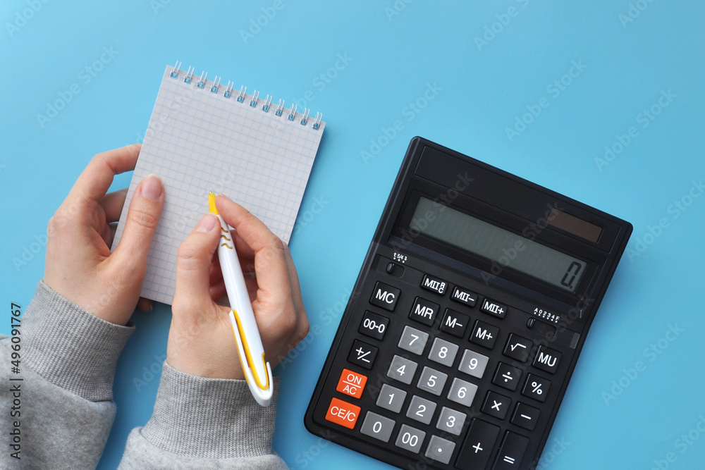 A person makes notes and calculations. Symbol of data counting and problem solving A person makes notes and calculations. Symbol of data counting and problem solving