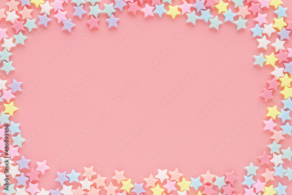 The stars in various colors on the pink background