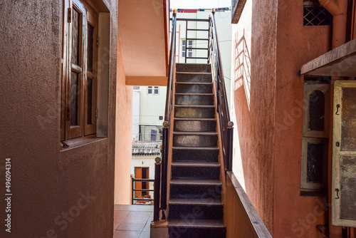 Stock photo of empty inside staircase in the residencial building  black color painted grill on both side of the stairs . Picture captured during day time at Bangalore  Karnataka  India.