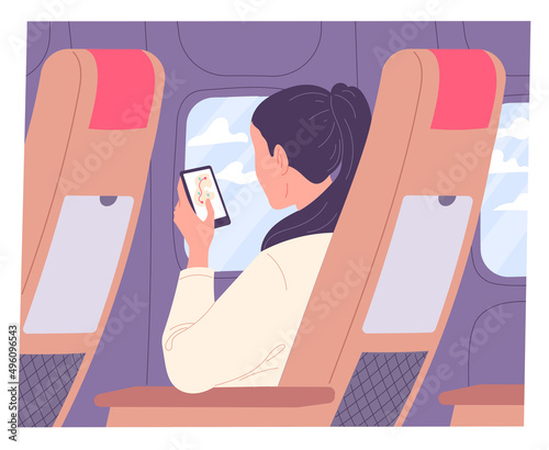 Woman with smartphone on airplane during flight