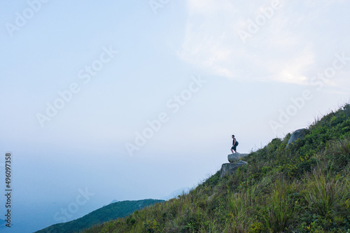 Hiking man on cliff alone. Free explorer in countryside. located in Clear Water Bay, Hong Kong