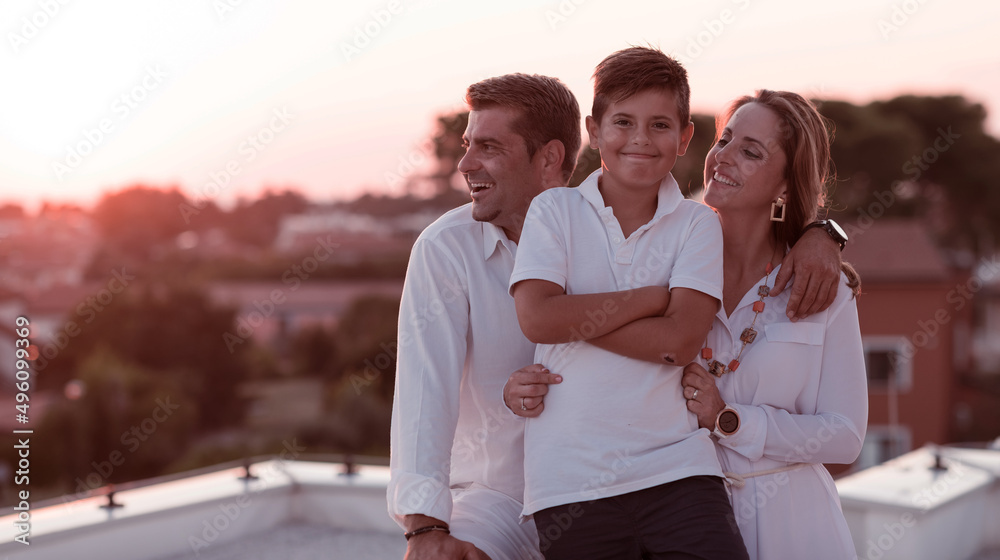 Happy family enjoys and spends time together on the roof of the house. Selective focus Happy family enjoys and spends time together on the roof of the house. Selective focus