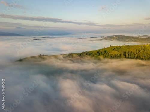 Green mountains of the Ukrainian Carpathians in the morning mist. Aerial drone view.