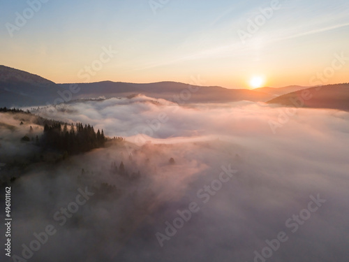 Sunrise over the fog in the Ukrainian Carpathians. Aerial drone view.