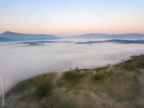 Sunrise over the fog in the Ukrainian Carpathians. Aerial drone view.