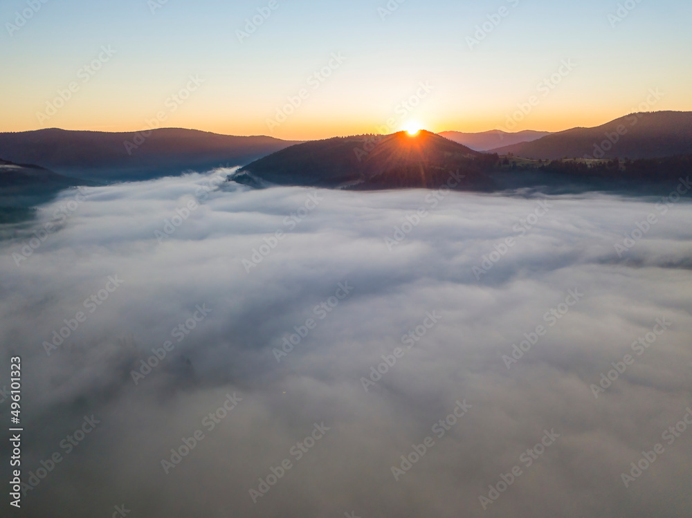 Sunrise over the fog in the Ukrainian Carpathians. Aerial drone view. Sunrise over the fog in the Ukrainian Carpathians. Aerial drone view.