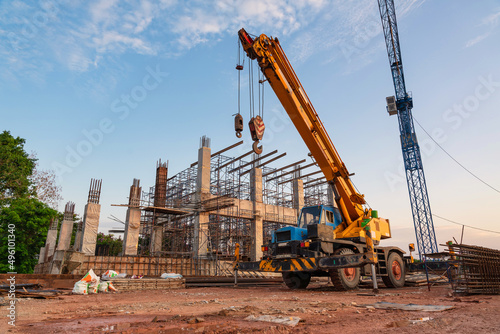 A Mobile Crane and tower crane for pouring concrete in construction site. photo
