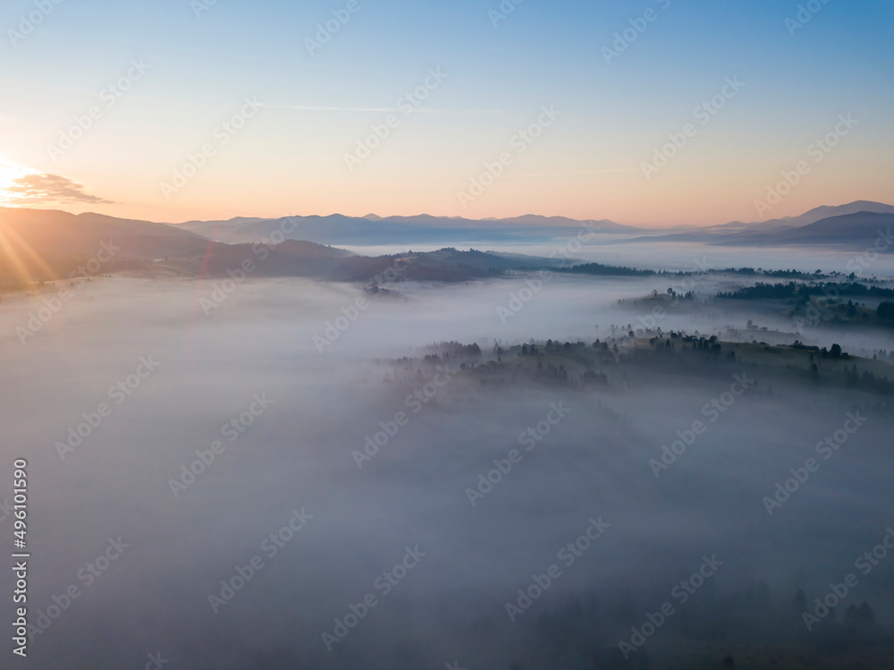 Sunrise over the fog in the Ukrainian Carpathians. Aerial drone view. Sunrise over the fog in the Ukrainian Carpathians. Aerial drone view.
