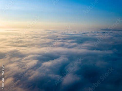 High flight above the clouds. Aerial drone view.