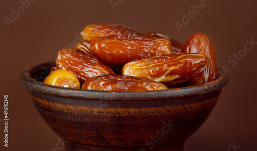 Clay cup with ripe dried dates.