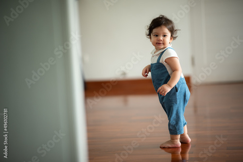 cute toddler little child family concept, baby learning to walk with father and mother to help care and holding hand, first step with childhood parent support, small love portrait little boy at home