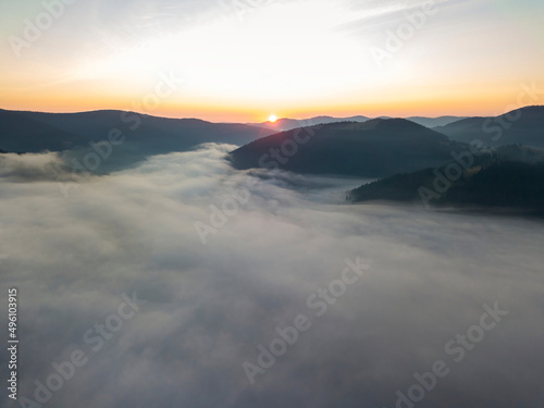 Sunrise over the fog in the Ukrainian Carpathians. Aerial drone view.
