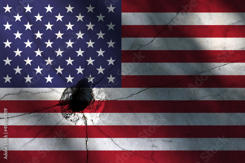 American flag with big crack or bullet hole. Military conflict and war in country concept background photo