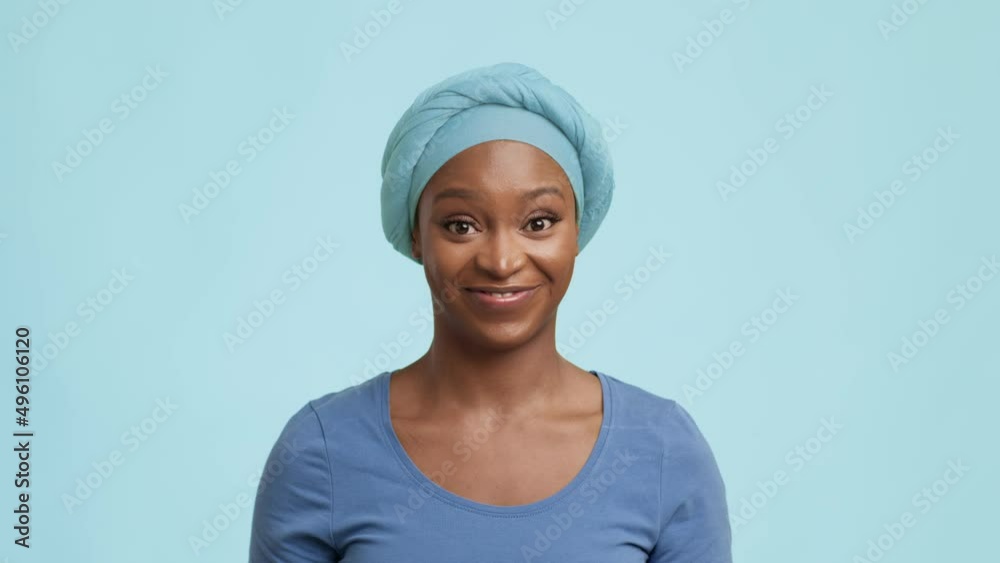 Playful African American Female Raising Eyebrows Posing Over Blue Background Playful African American Female Raising Eyebrows Posing Over Blue Background