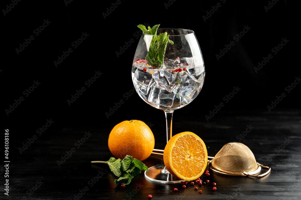 Modern Cocktail gin tonic herb spices fishbowl glass plain background