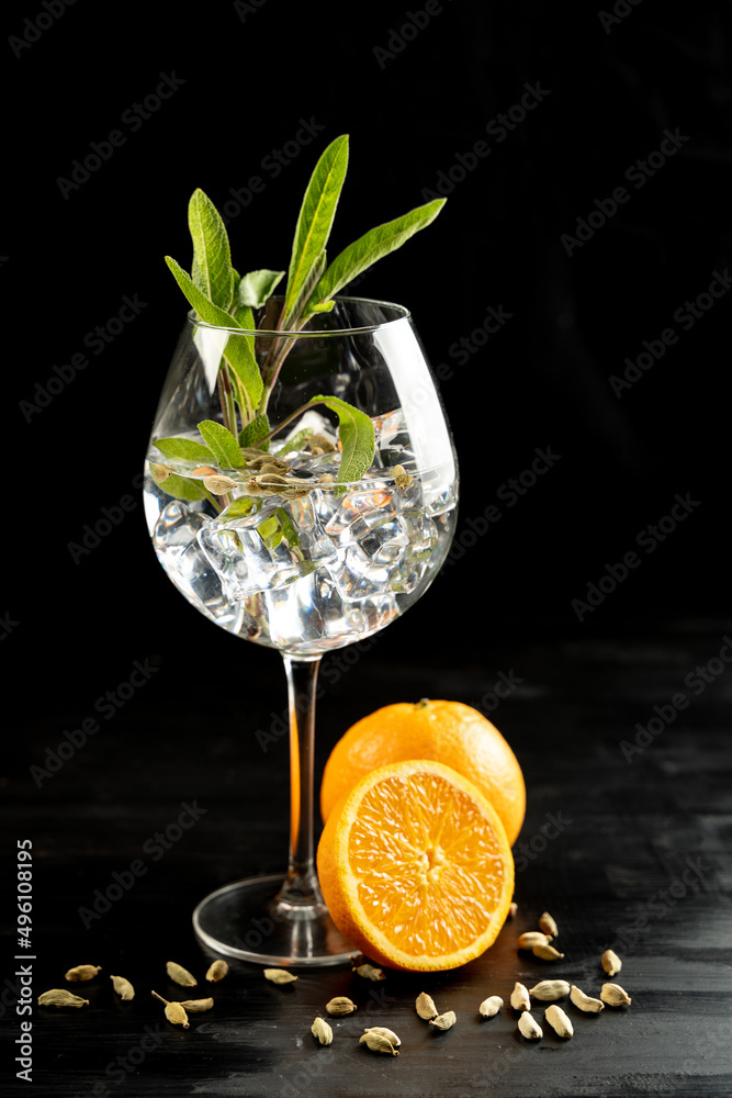 Modern Cocktail gin tonic herb spices fishbowl glass plain background