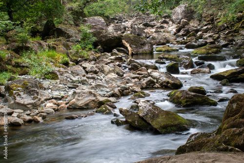 Fast flowing water/waterfalls flowing through the Aberglaslyn Pass near to Beddgelert, in Snowdonia National Park, north Wales photo