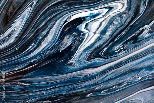 Fluid art texture. Abstract backdrop with swirling paint effect. Liquid acrylic picture with flows and splashes. Mixed paints for interior poster. Black, navy blue and white overflowing colors.