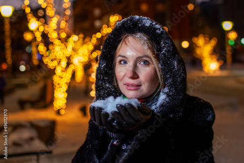 Woman on the background of night christmas illumination