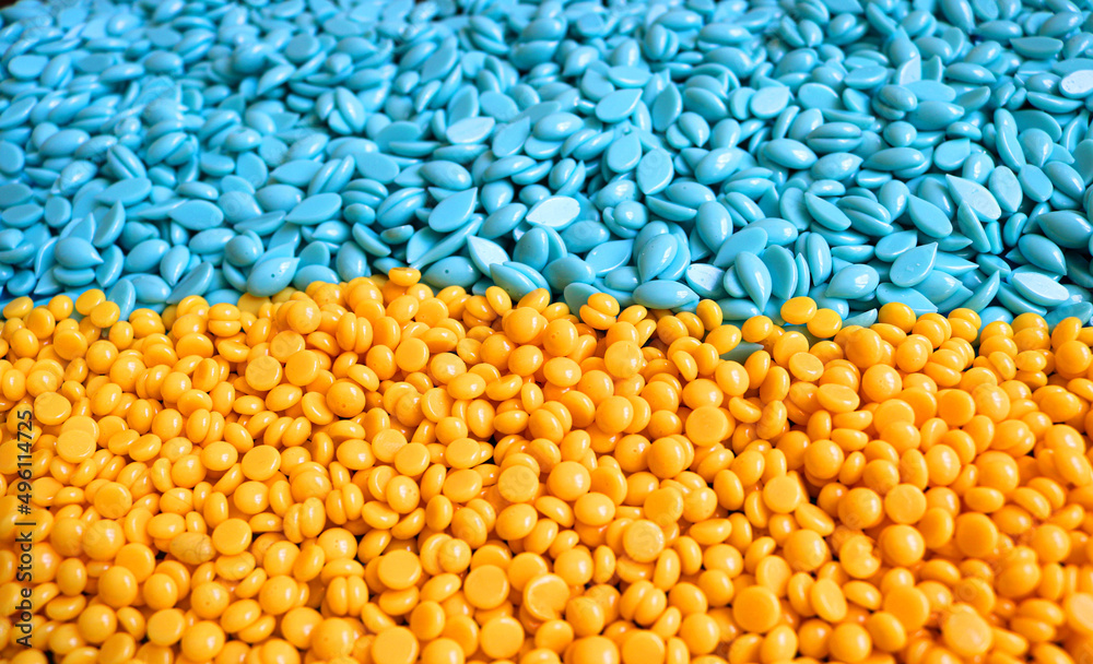hard wax beans in perspective with different formats and the colors of the Ukrainian flag in yellow and blue - closeup in perspective