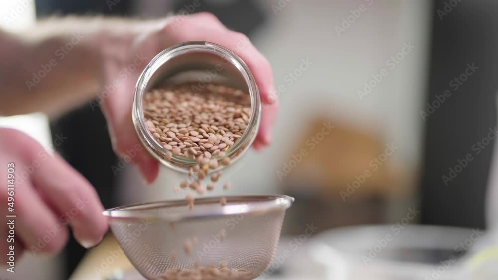 Pour the lens vegetable from glass jar in filter in slowmo 4K Pour the lens vegetable from glass jar in filter in slowmo 4K