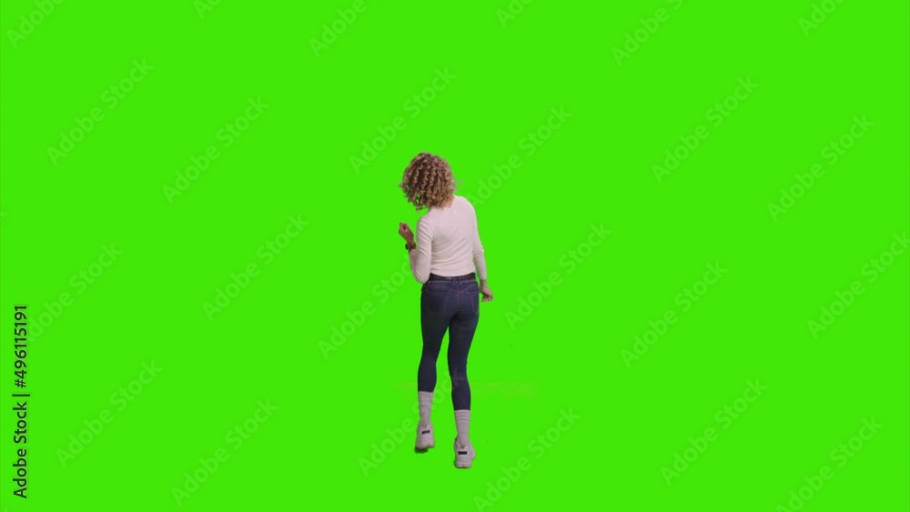 A beautiful wearing a fit jeans dancing with her hands raised on greenscreen A beautiful wearing a fit jeans dancing with her hands raised on greenscreen