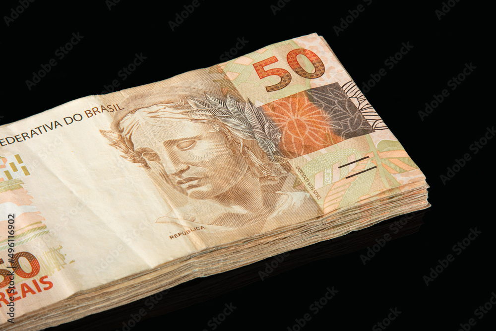 Brazilian money. 50 reais banknotes. Brazilian finance concept. Black background Brazilian money. 50 reais banknotes. Brazilian finance concept. Black background