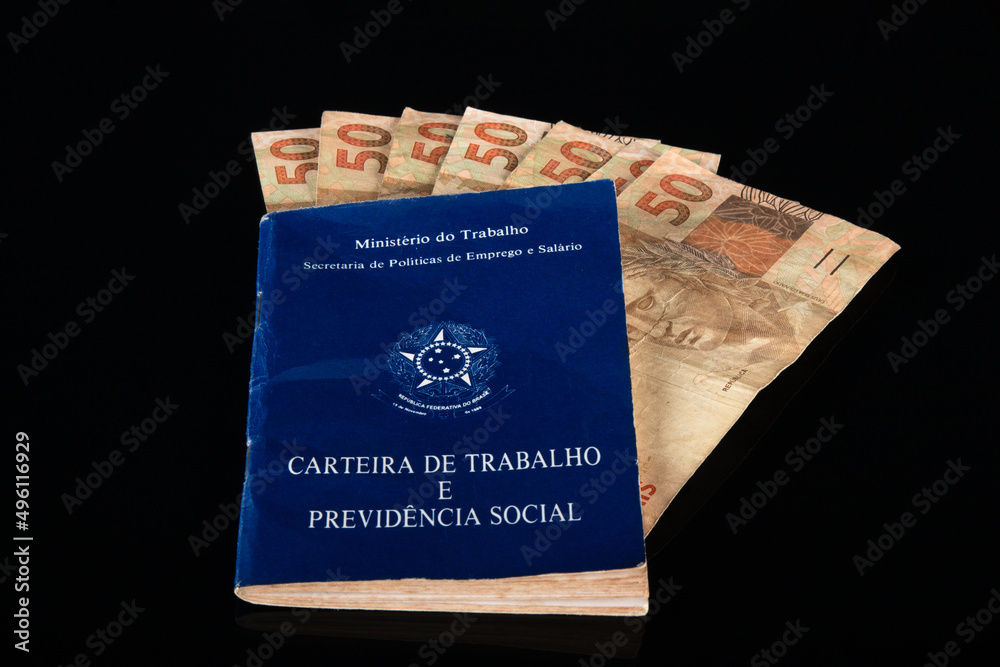 Fototapeta premium Brazilian document work and social security (Carteira de Trabalho e Previdencia Social) with Brazilian money banknotes