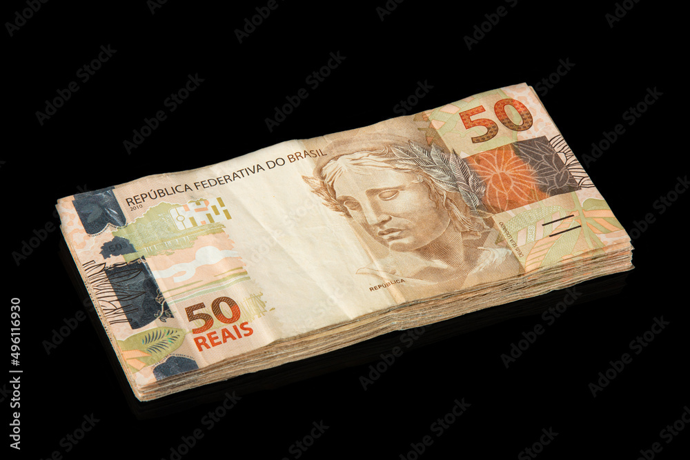 Brazilian money. 50 reais banknotes. Brazilian finance concept. Black background Brazilian money. 50 reais banknotes. Brazilian finance concept. Black background