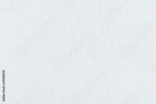 Full frame of white granulated sugar, texture and copy space.