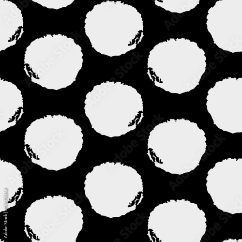 Vector black and white textured polka dots seamless design.