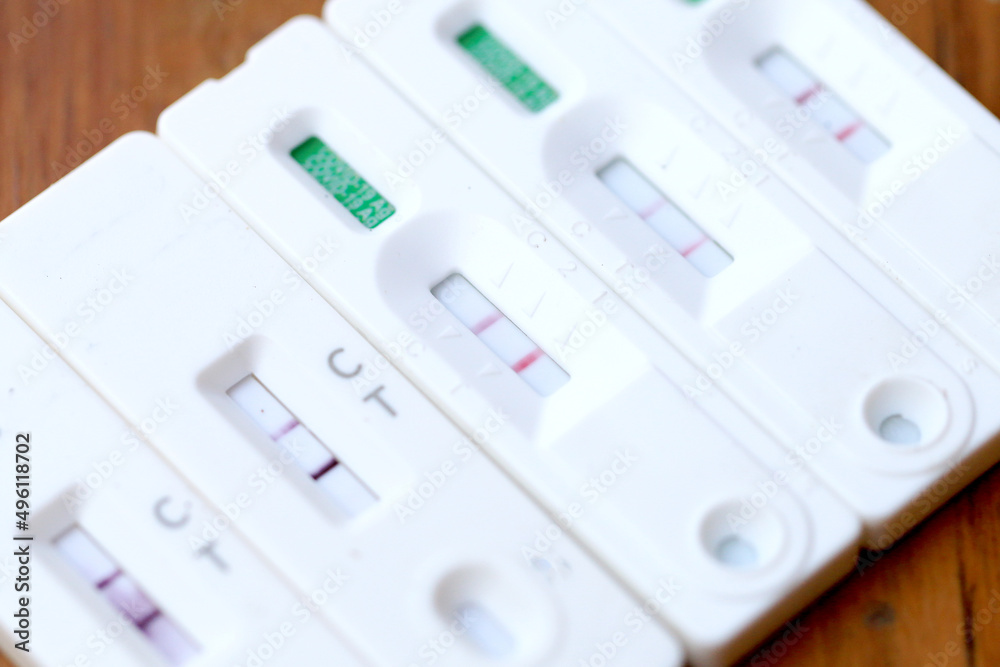 Antigen Test kit with Positive result during swab COVID-19 testing. Coronavirus Self nasal or Home test, Lockdown and Home Isolation concept. Antigen Test kit with Positive result during swab COVID-19 testing. Coronavirus Self nasal or Home test, Lockdown and Home Isolation concept.