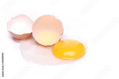 selective focus, half cracked egg and yolk isolated on a white background with clipping path. top view