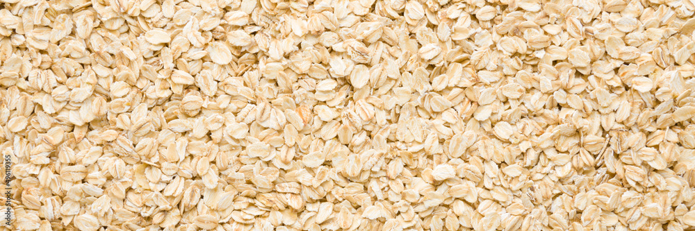 Dry rolled oat background. Wide banner. Closeup. Healthy food. Top down view. Dry rolled oat background. Wide banner. Closeup. Healthy food. Top down view.