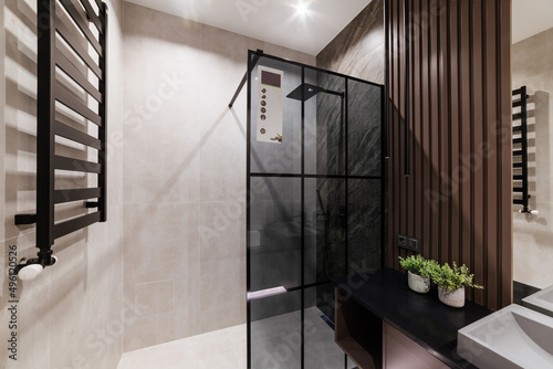 bright bathroom interior with glass wall and shower photo
