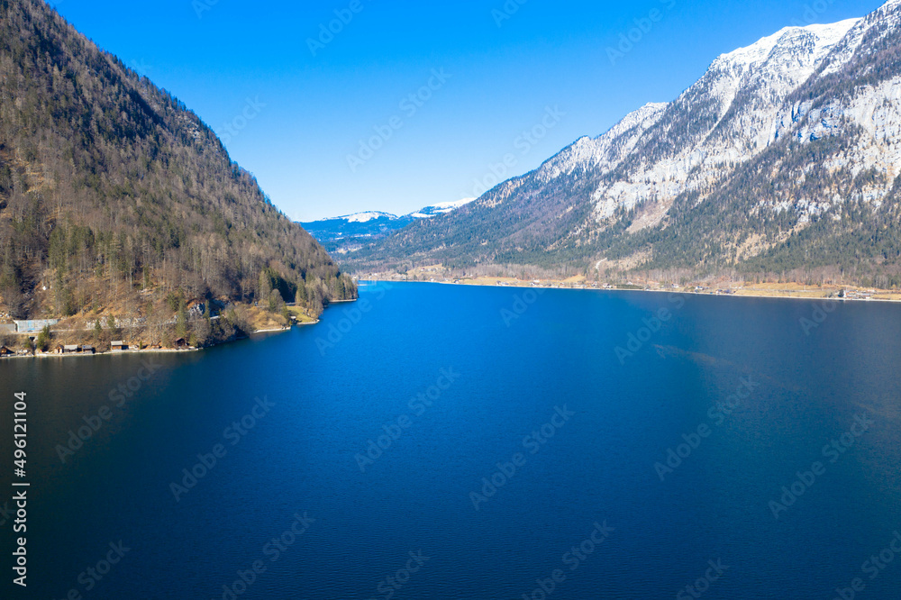 Amazing aerial view of Lake Hallstatt in Austria. The Hallstätter Lake is one of the most famous lakes in the upper austrian Salzkammergut. Dachstein mountains in the background. Hallstatt, Austria
