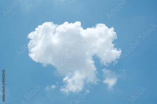 White fluffy cloud in the deep blue sky, single cloud natural background © waranyaphoto