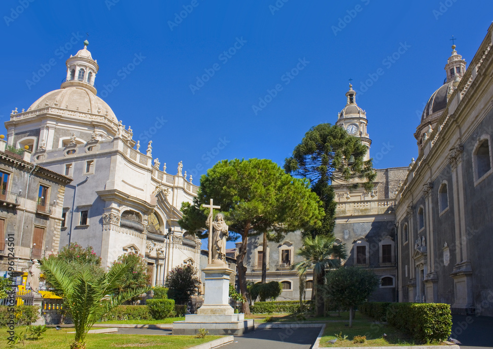 Sculpture of St Agata and view of Church of the Abbey of Santa Agata in Catania, Italy, Sicily